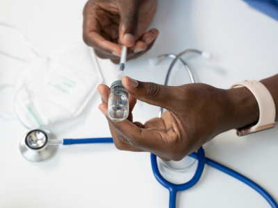 Close up of a medical professional preparing a syringe
